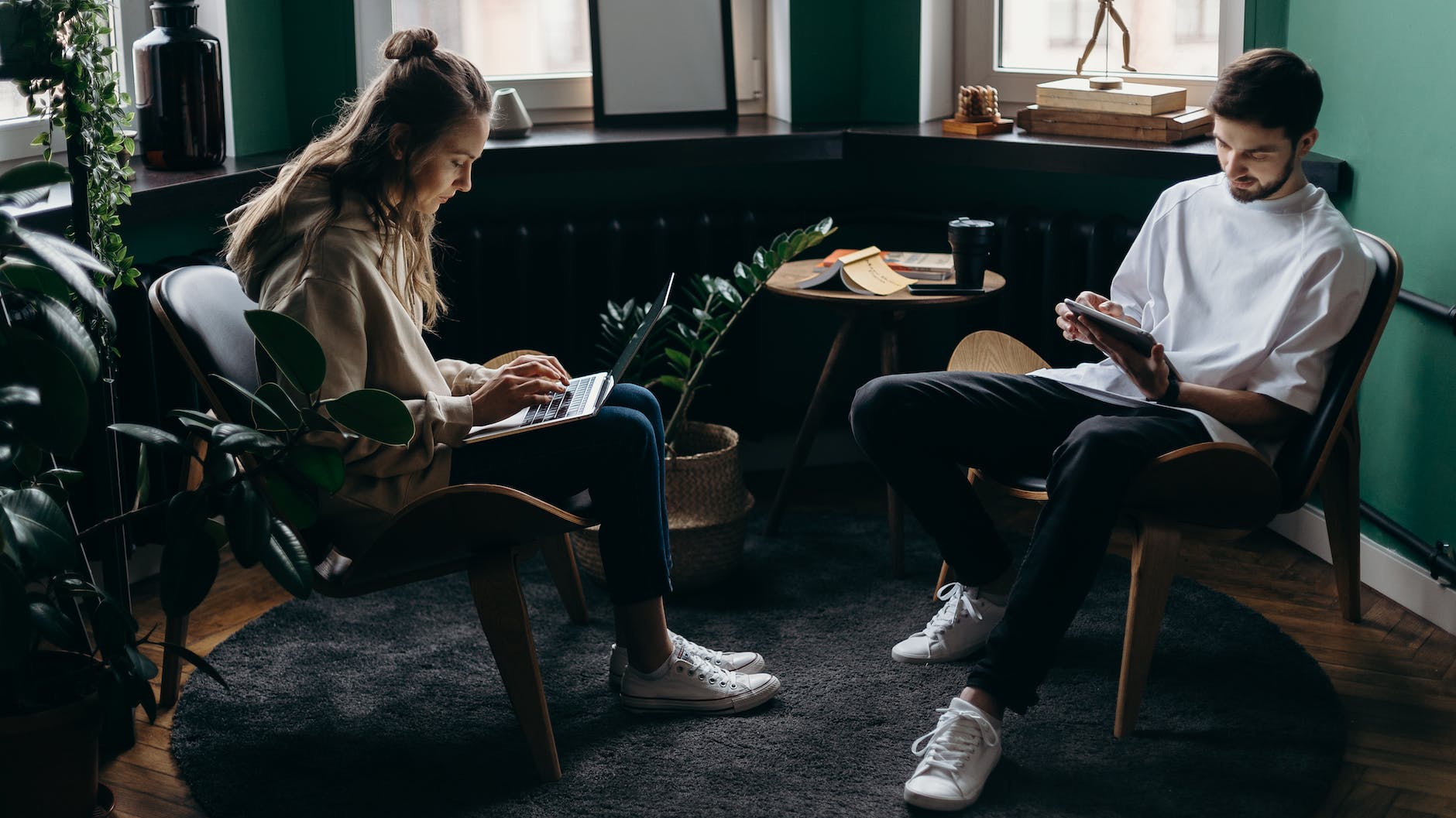 photo of two person using their gadgets